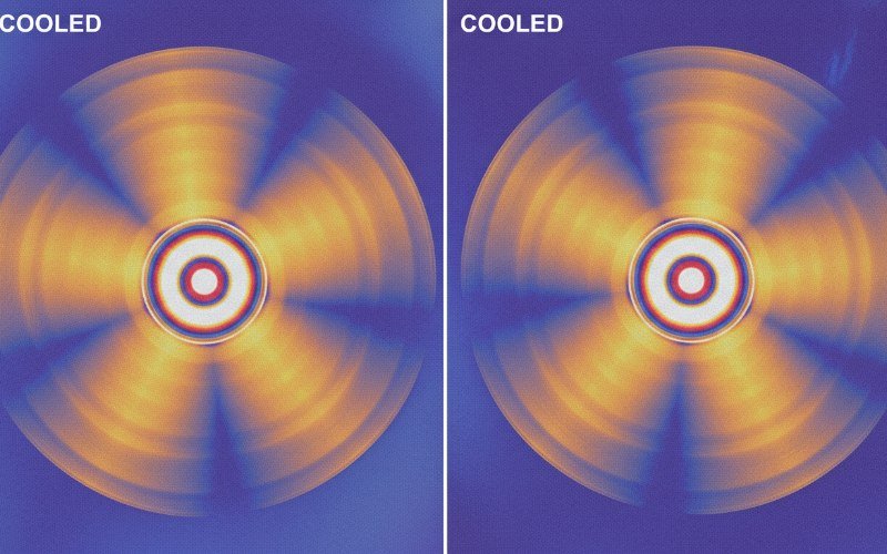 Engineer integrating thermal core into UAV payload showing size comparison